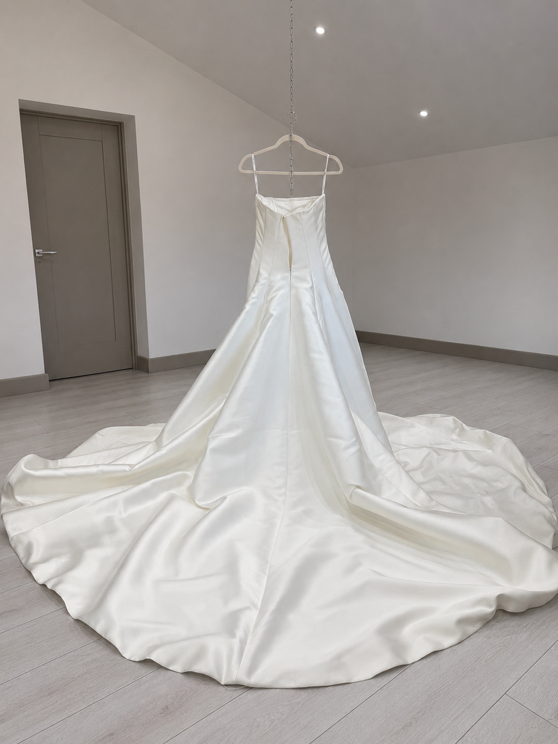 Wedding dress with full train before a ballroom bustle