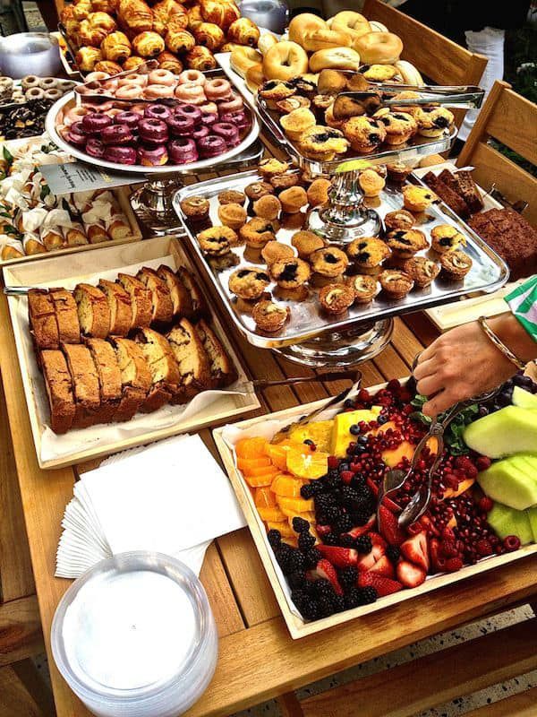 A table topped with a variety of desserts and fruits
