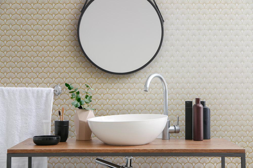 A bathroom with a sink and a mirror on the wall.