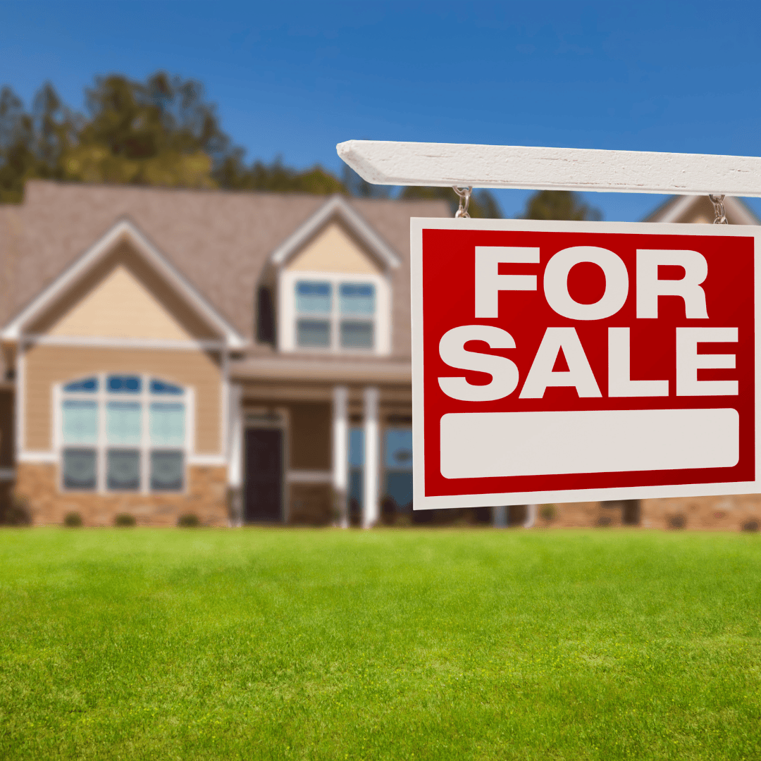 A for sale sign in front of a house