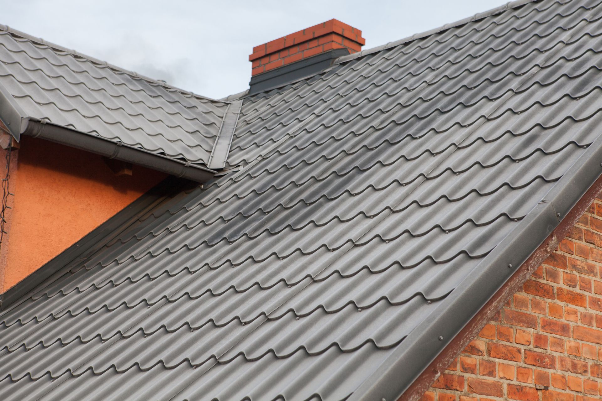 A close up of a roof with a chimney on top of it.