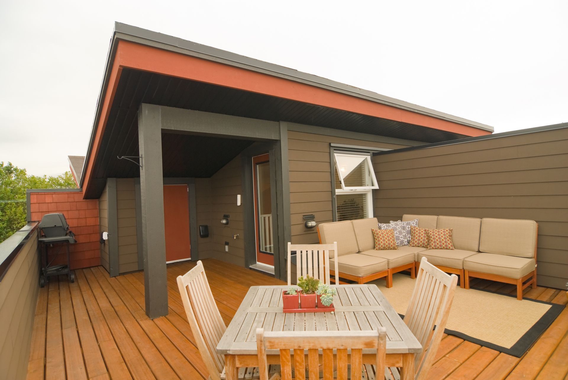 A deck with a table and chairs and a couch