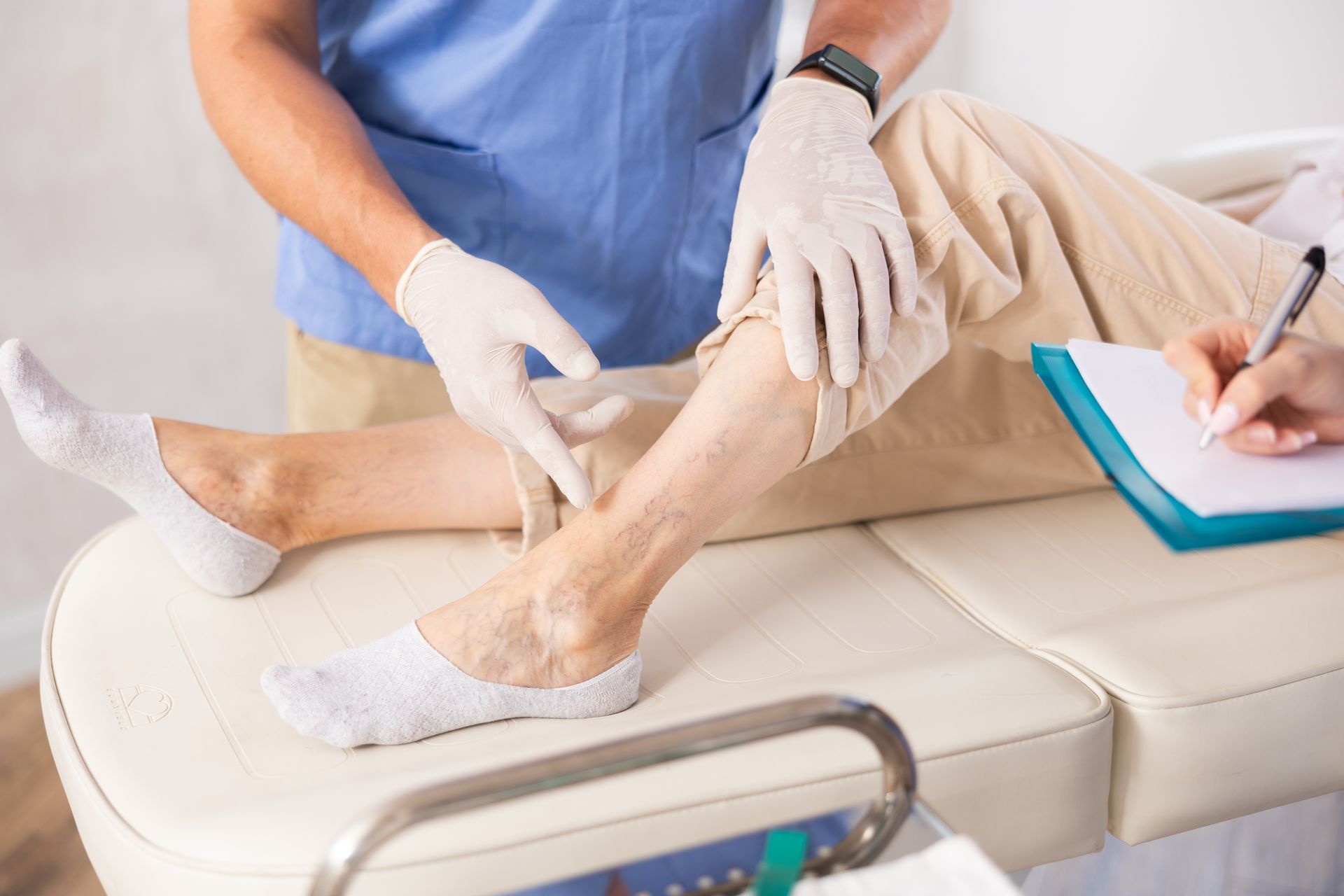 Doctor examining a patient's leg for varicose vein symptoms. Doctor examining a patient's leg for varicose vein symptoms.