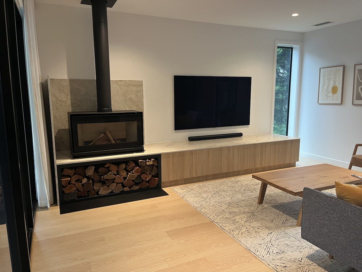 Modern Living Room With a Wood Stove, Wall-mounted TV — JDS Kitchens & Detailed Joinery in Albion Park Rail, NSW