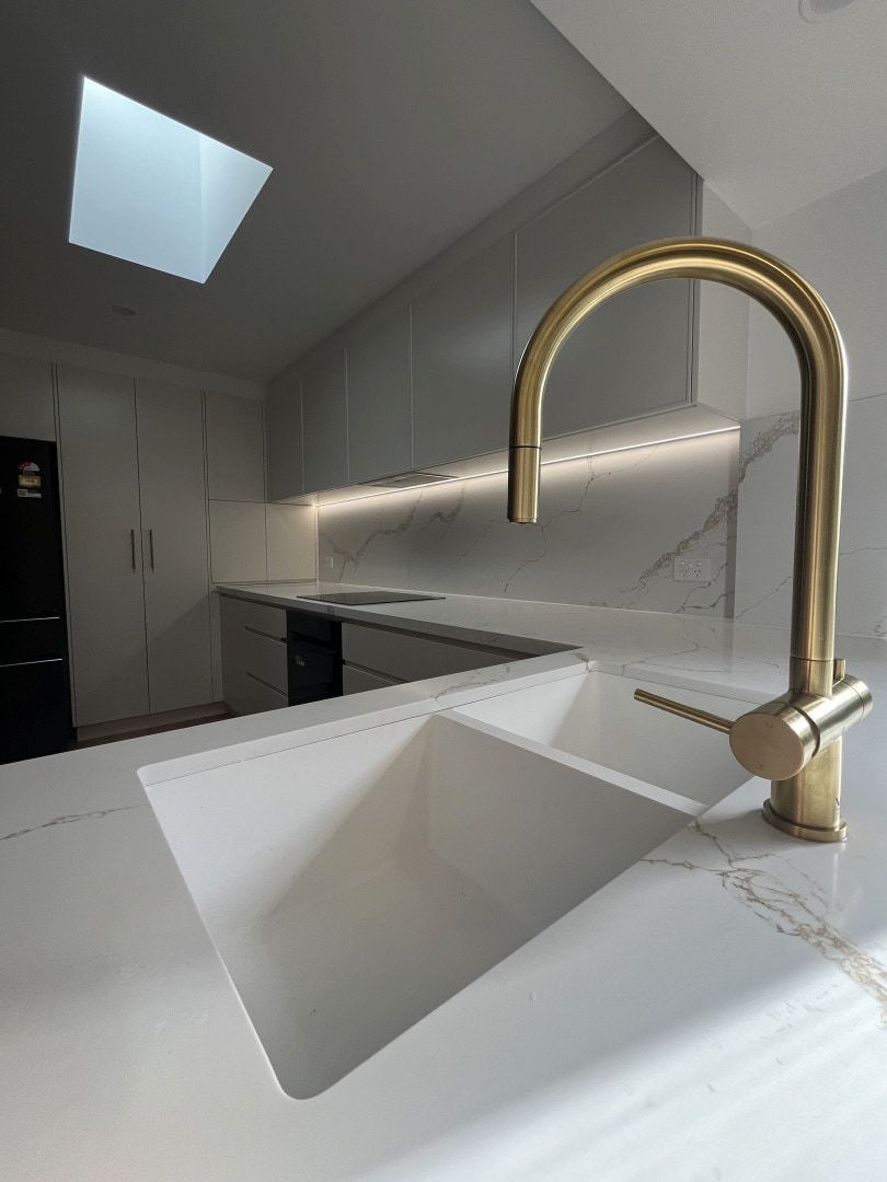 Modern Kitchen With White Marble Counters, Gold Faucet, and Square — JDS Kitchens & Detailed Joinery in Albion Park Rail, NSW