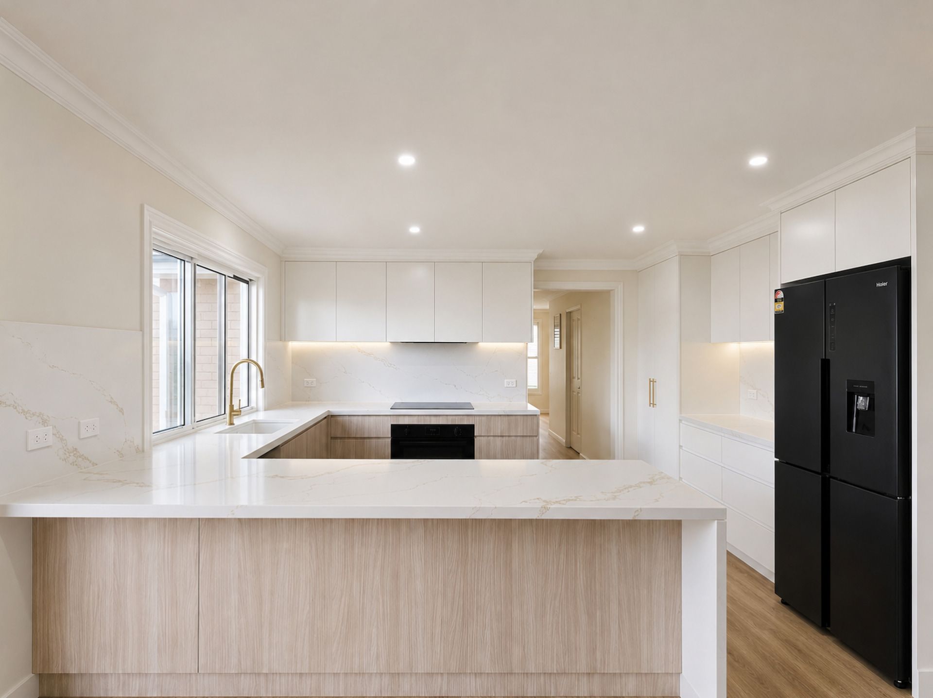 Bright Modern White Kitchen with Island, Built In Oven, and Black Refrigerator — JDS Kitchens & Detailed Joinery in Albion Park Rail, NSW