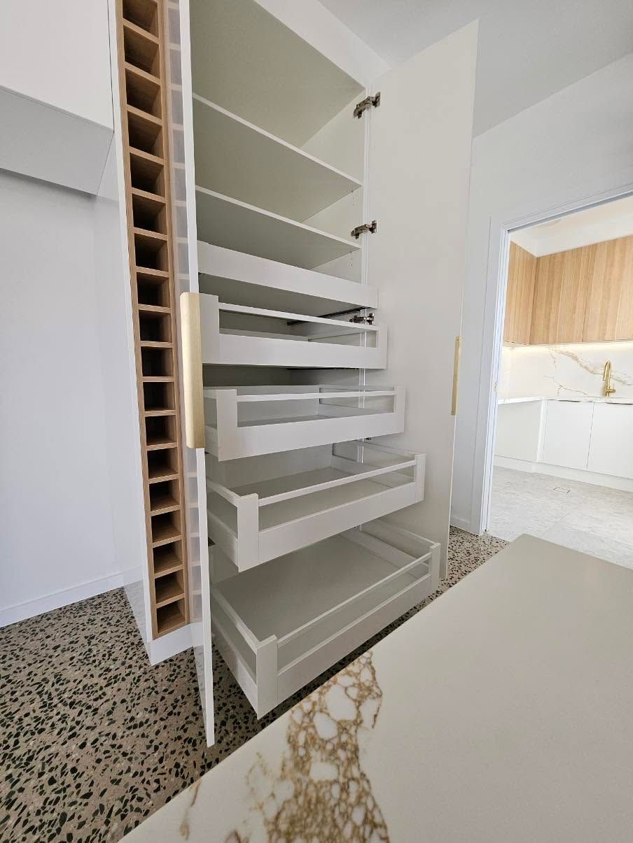 Open White Kitchen Cabinet with Pull-Out Shelves and Wire Storage Inserts — JDS Kitchens & Detailed Joinery in Albion Park Rail, NSW