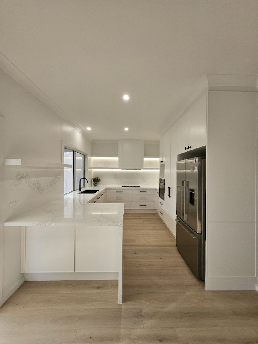 Bright Modern White Kitchen With Light Wood Floors — JDS Kitchens & Detailed Joinery in Albion Park Rail, NSW