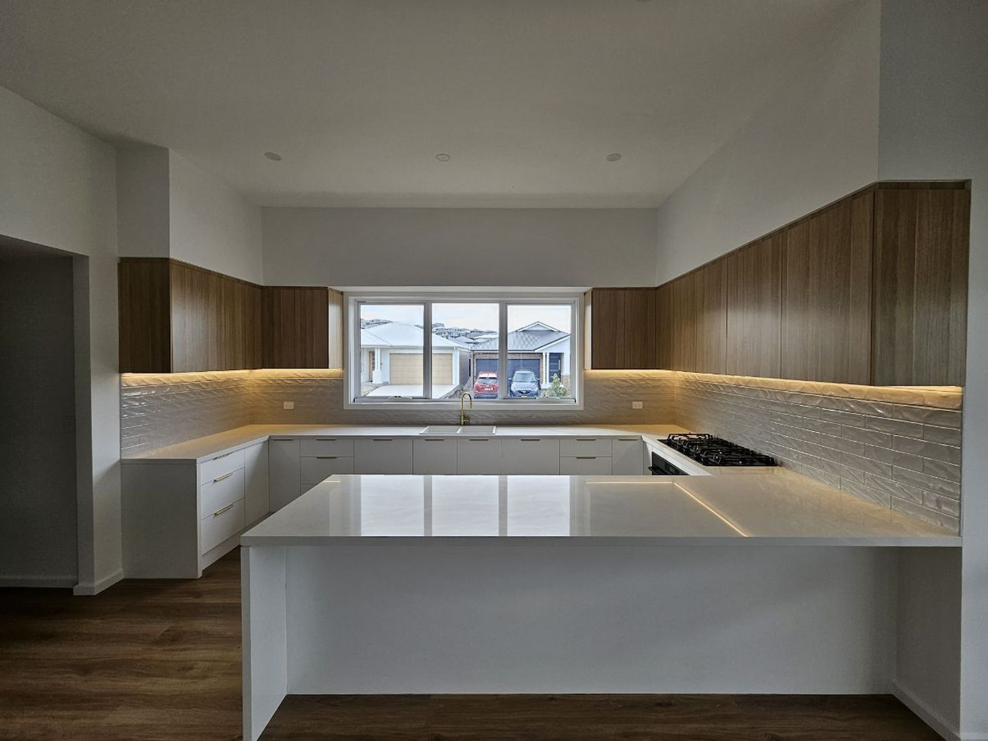 Modern Minimalist Kitchen With Wood Cabinets — JDS Kitchens & Detailed Joinery in Albion Park Rail, NSW