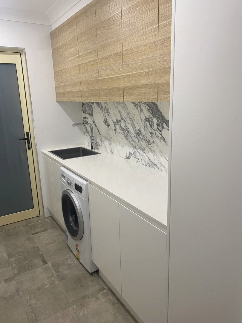 Modern Laundry Room With White Cabinets — JDS Kitchens & Detailed Joinery in Albion Park Rail, NSW