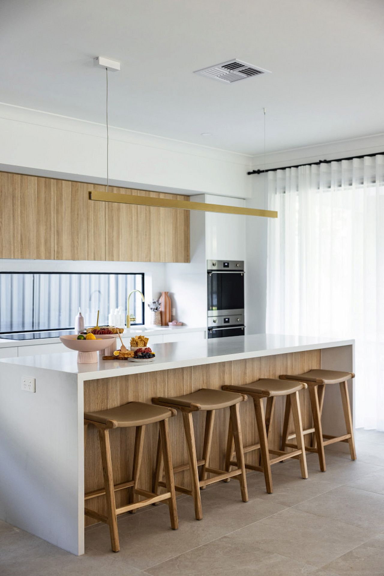 Modern Kitchen with White Island and Wooden Stools — JDS Kitchens & Detailed Joinery in Albion Park Rail, NSW