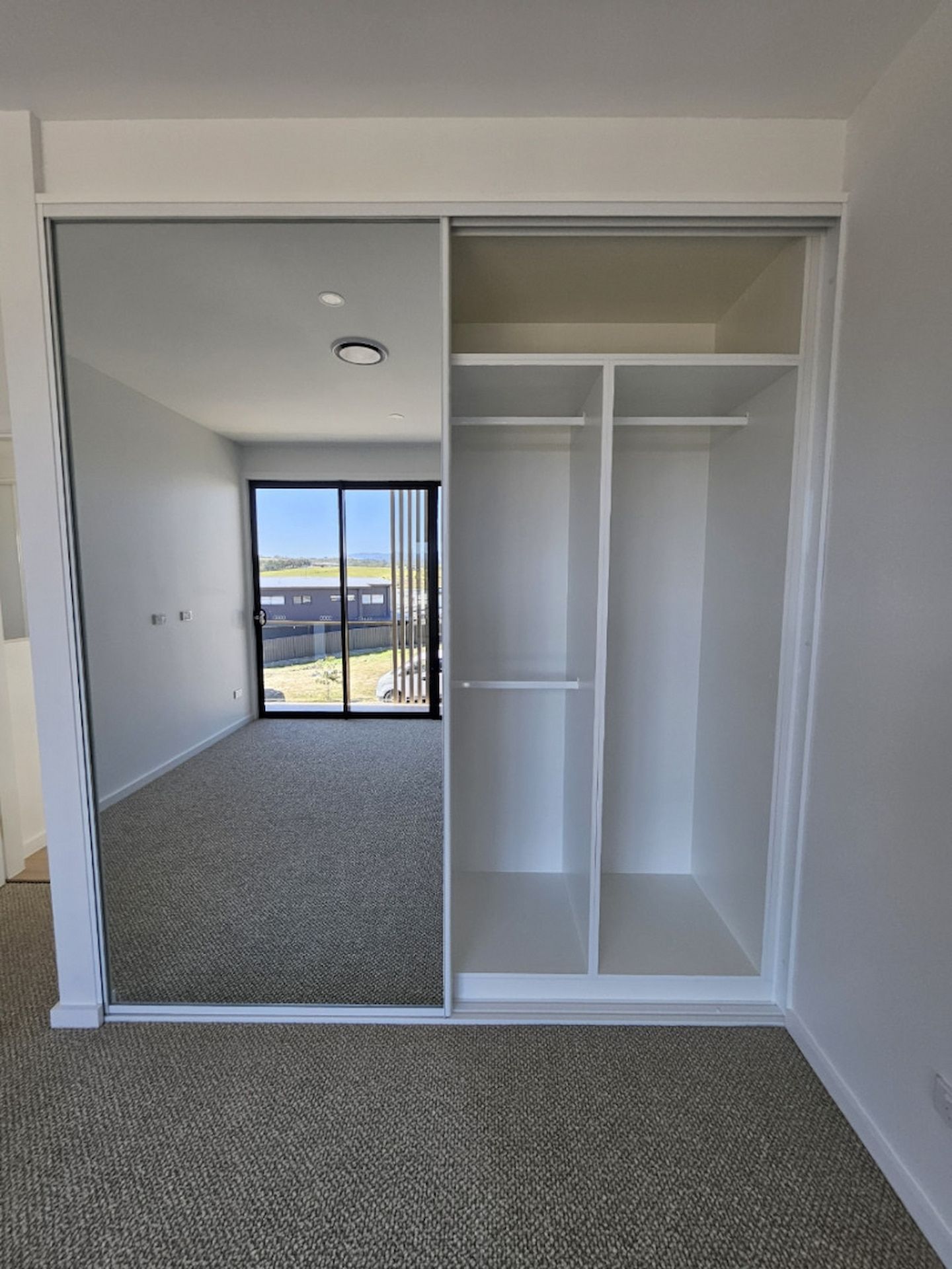 Bedroom With Mirrored Closet Doors — JDS Kitchens & Detailed Joinery in Albion Park Rail, NSW