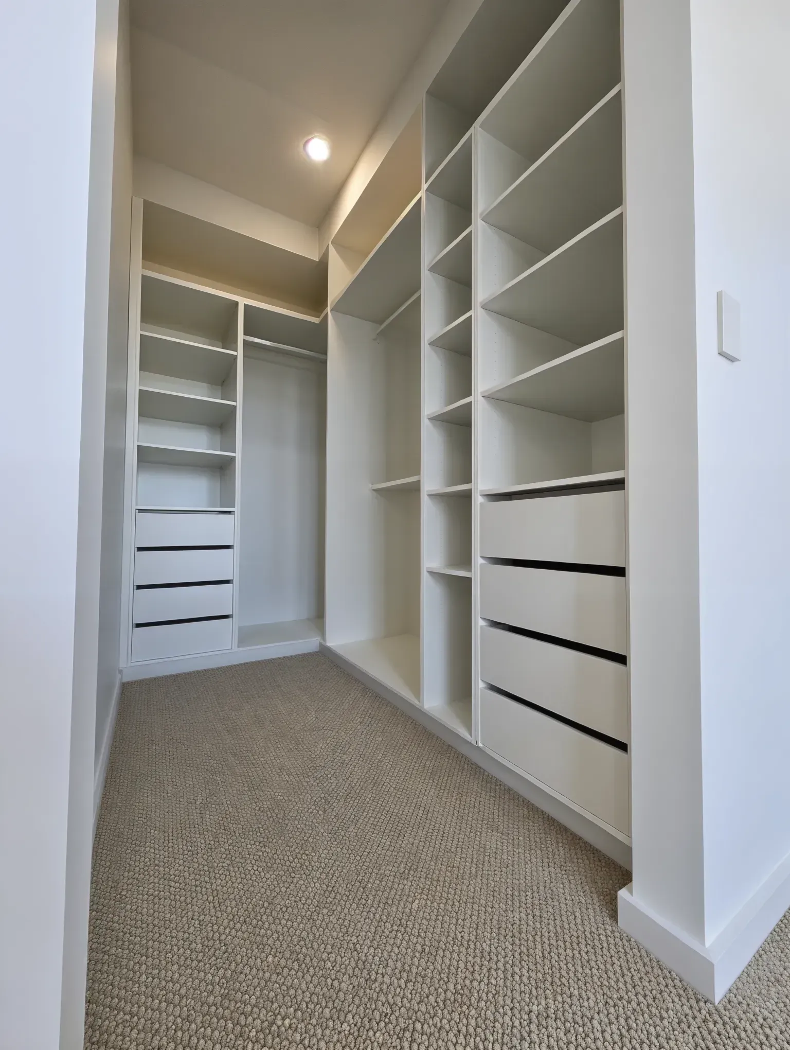 Empty Walk-in Closet With White Shelves — JDS Kitchens & Detailed Joinery in Albion Park Rail, NSW