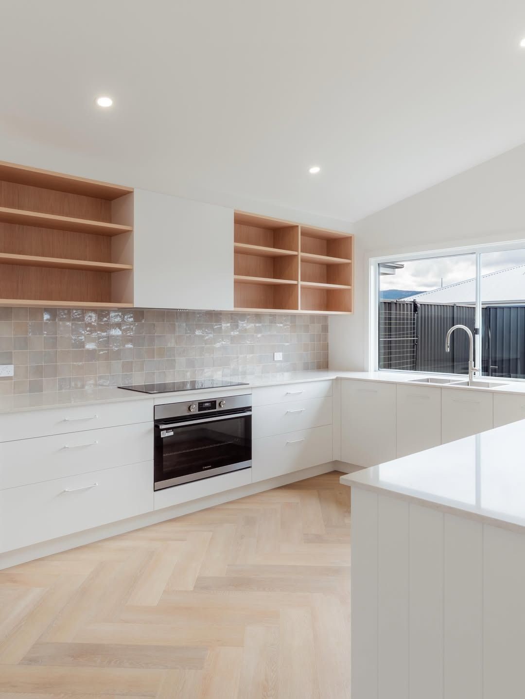 Modern Kitchen With Cabinets, Wood Ceiling, and a Dining Table — JDS Kitchens & Detailed Joinery in Albion Park Rail, NSW