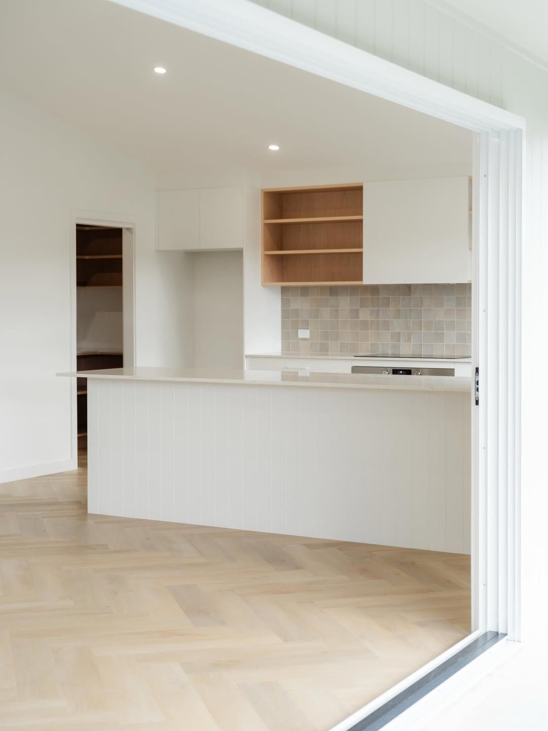 Bright Empty Modern Kitchen With White Cabinets — JDS Kitchens & Detailed Joinery in Albion Park Rail, NSW