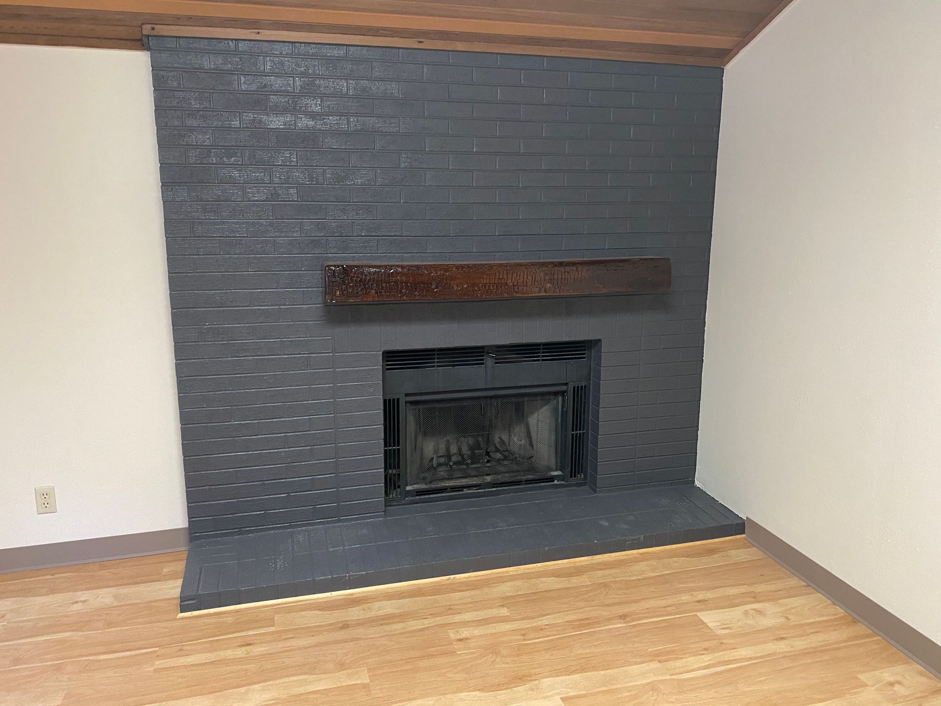 There is a fireplace in the corner of the room.