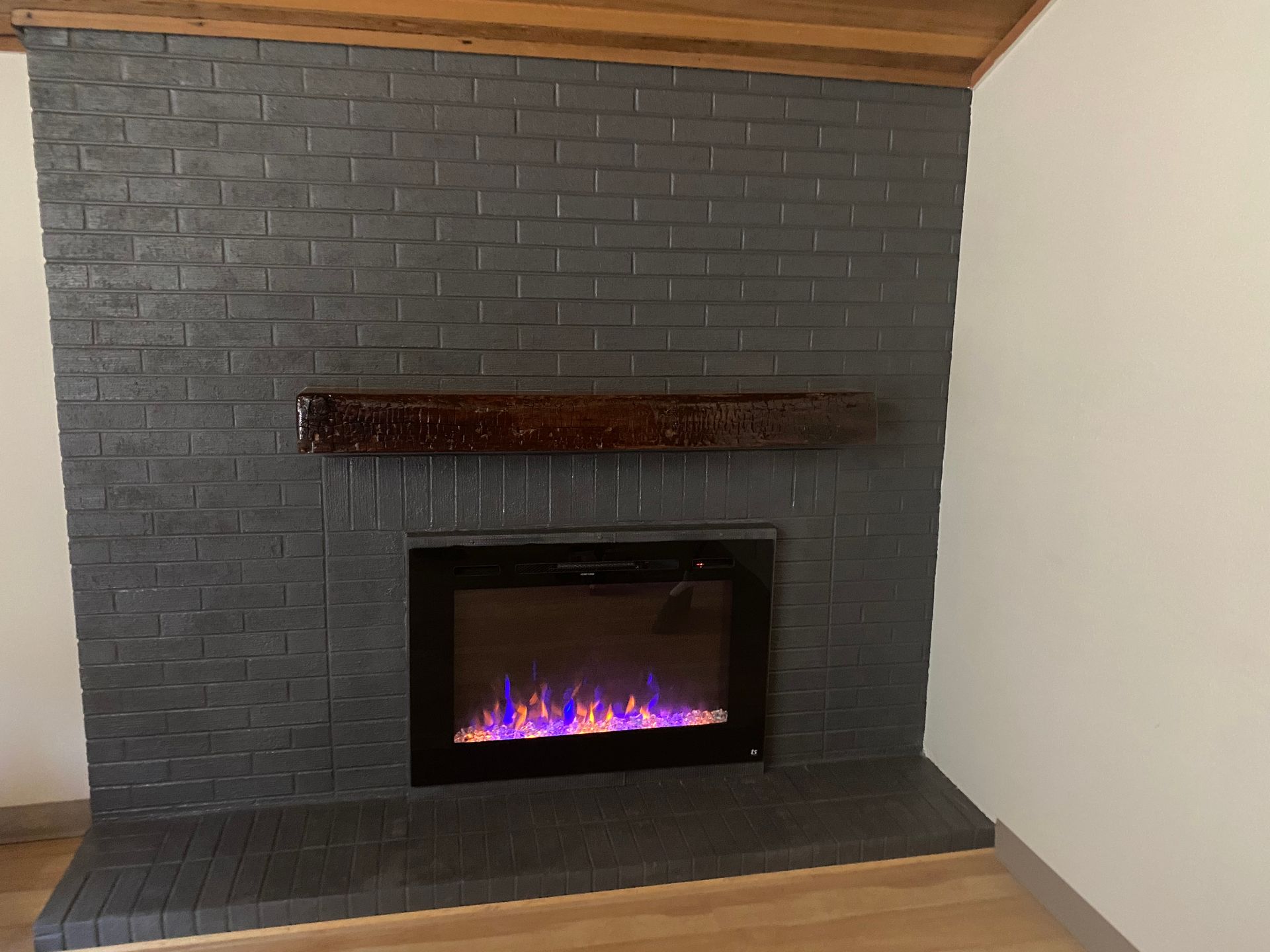 There is a fireplace in the corner of the room.