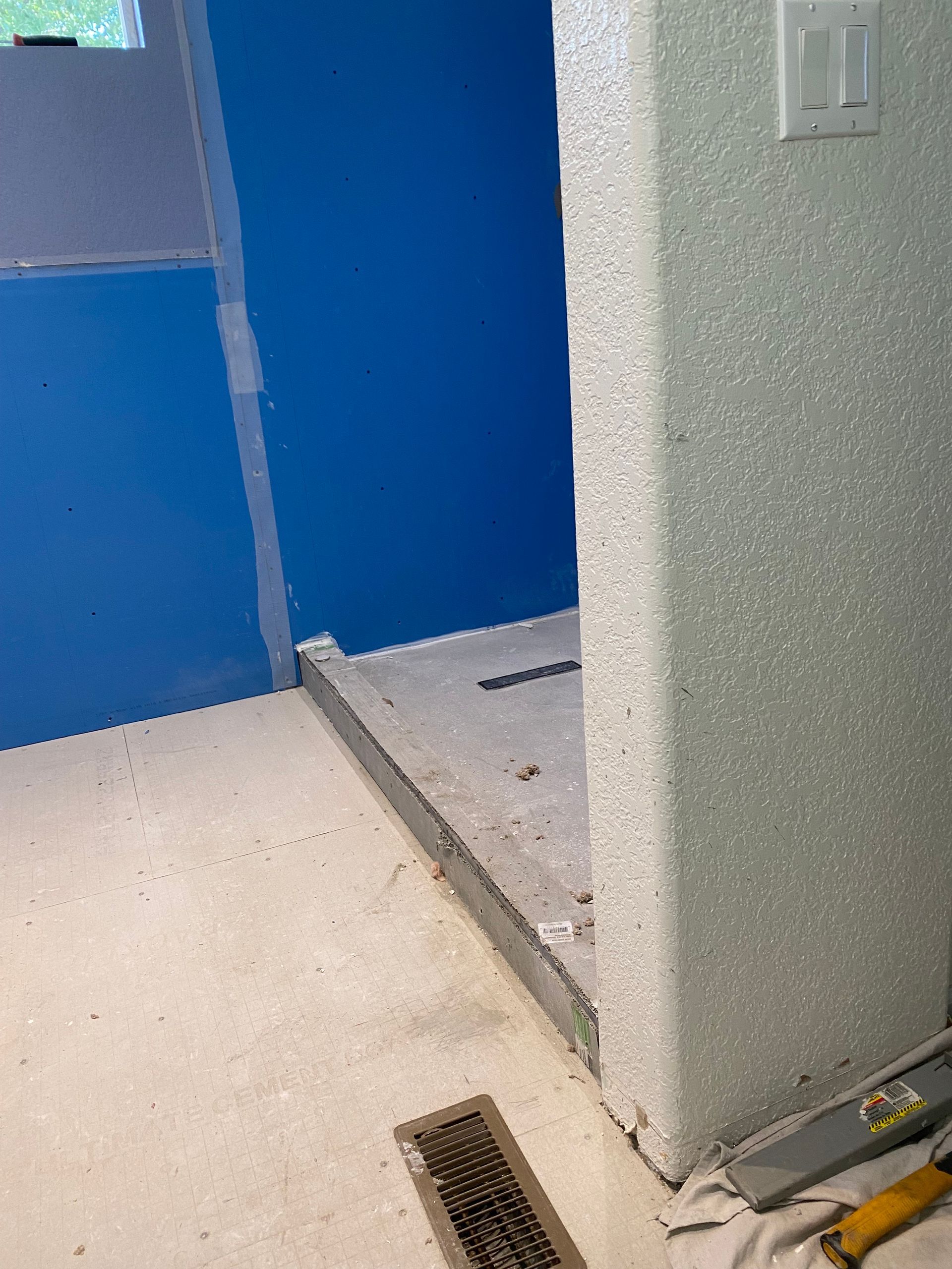 A room with a blue wall and a white floor