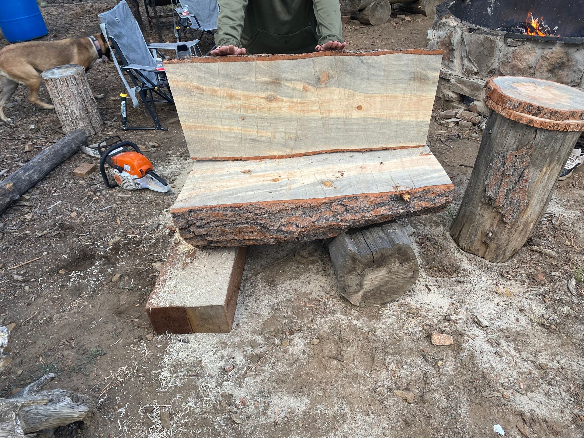 A person is cutting a piece of wood with a chainsaw.