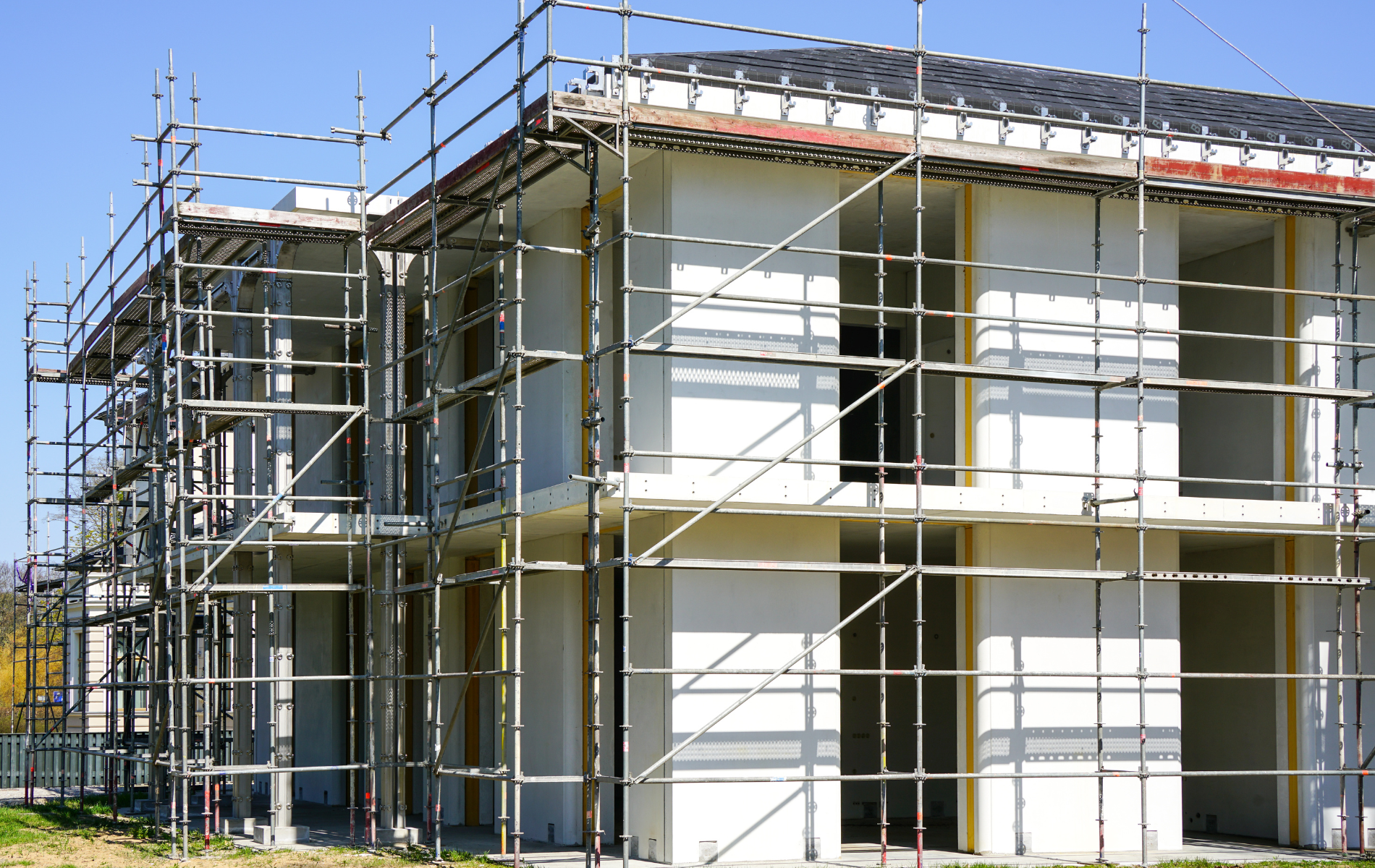A house is being built with scaffolding around it.