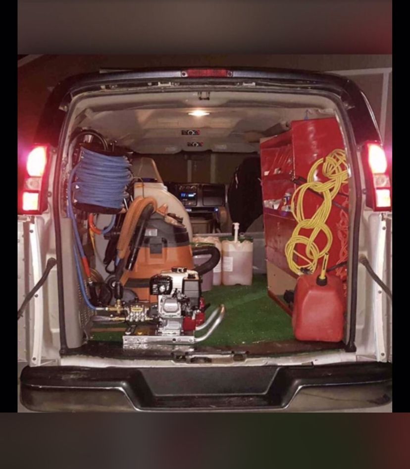 the back of a van filled with tools and a vacuum cleaner