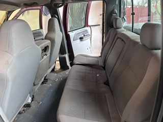 the back seat of a truck with a couch in it .