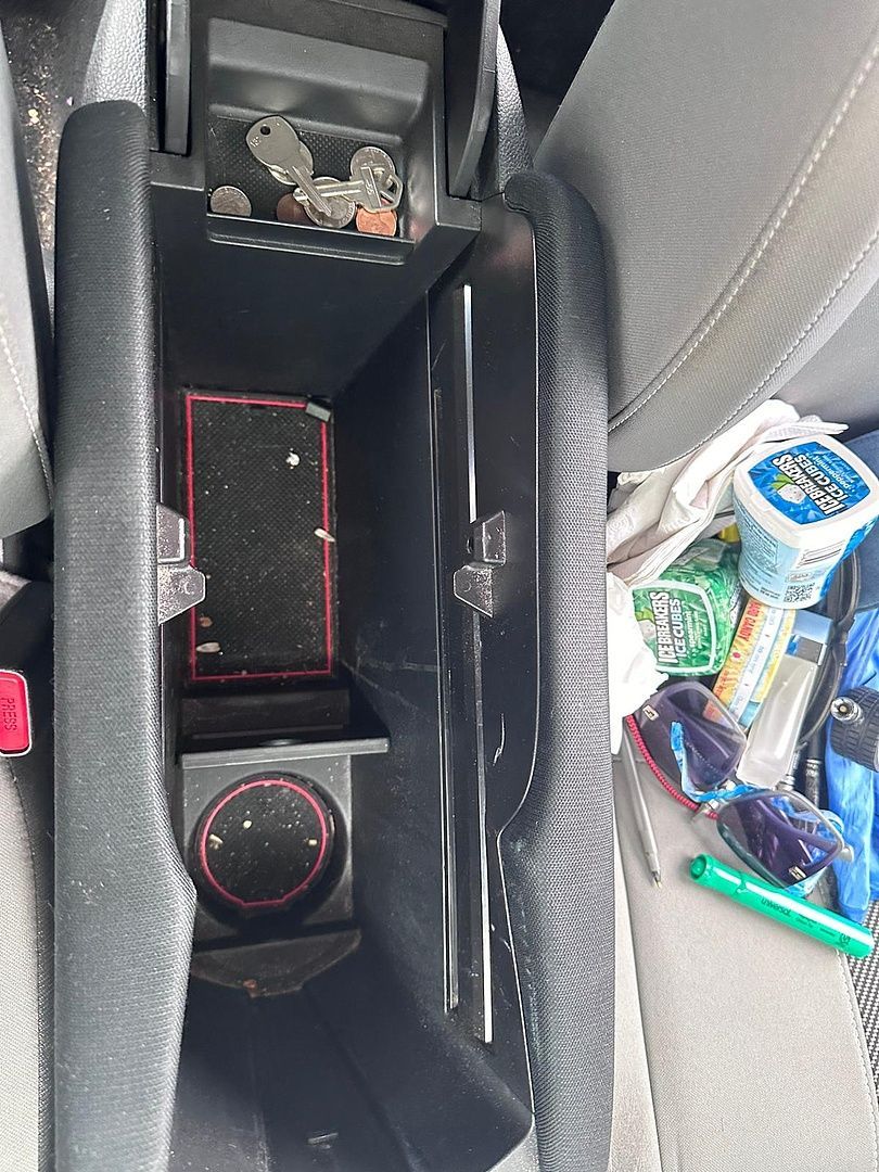 a car console with a lot of items in it .