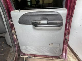the inside of a purple truck with the door open .