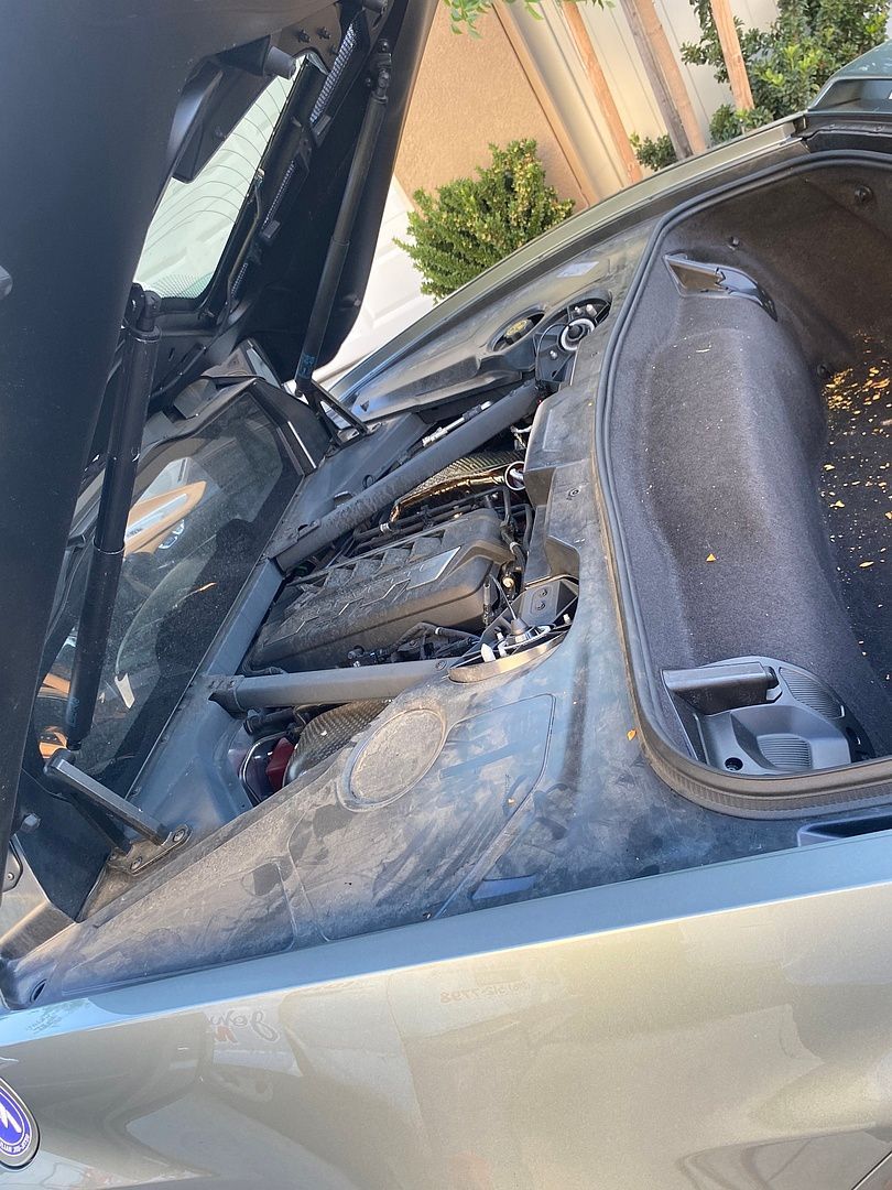 the hood of a car is open and the engine is visible .