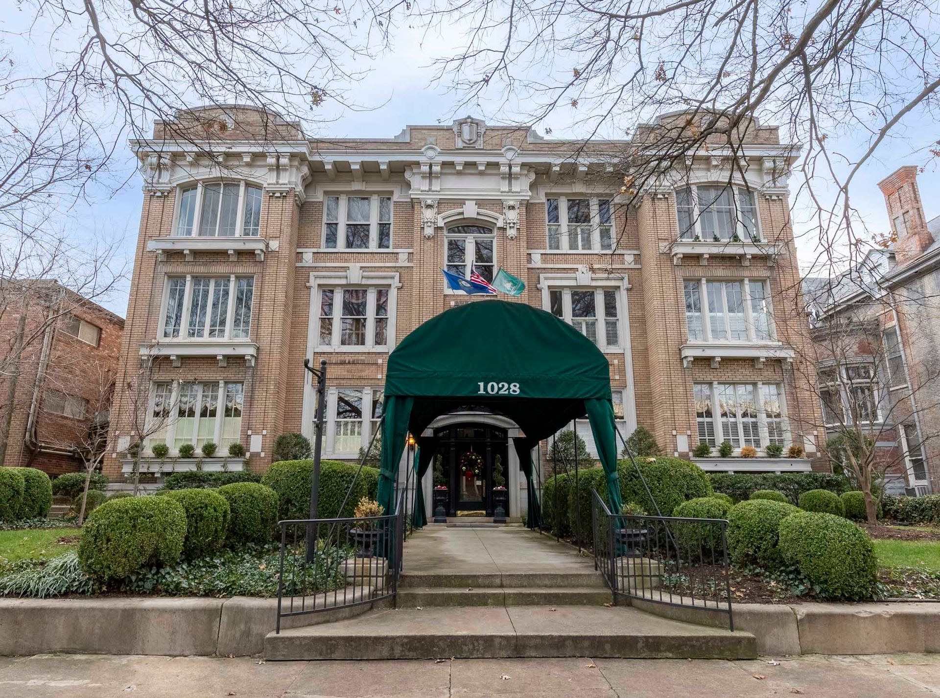 a large brick building with a green awning over the entrance