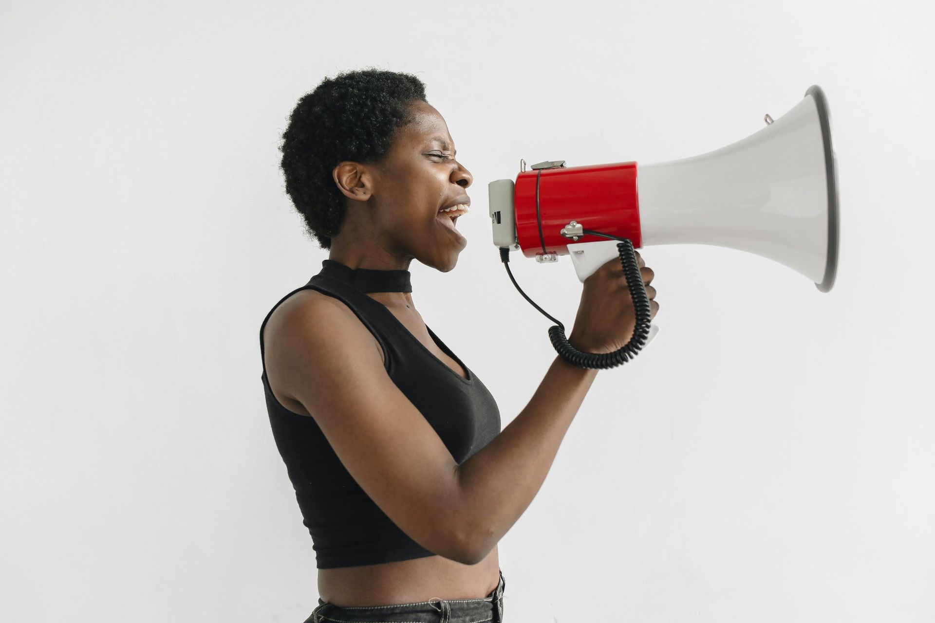 Black woman yelling into megaphone