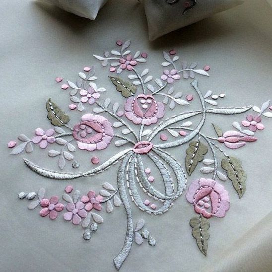 A white cloth with pink flowers and leaves on it