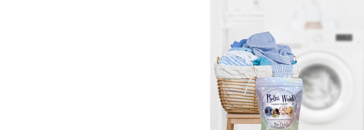 Basket of laundry with detergent pods beside a washing machine