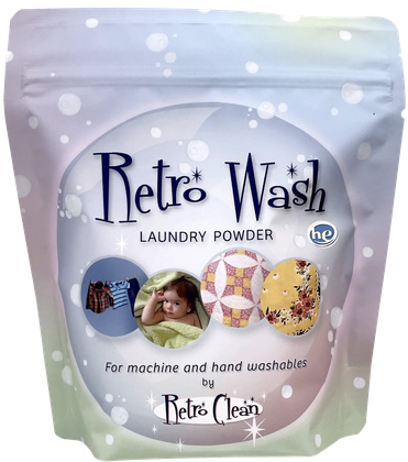 Retro Wash laundry powder pouch in pastel blue and green with snowflake dots and vintage-style lettering.