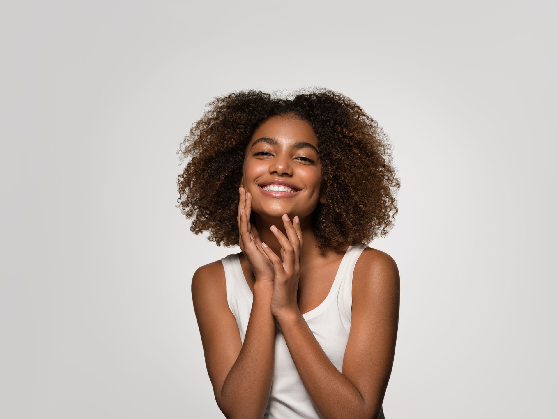 A woman in jacket is touching her face