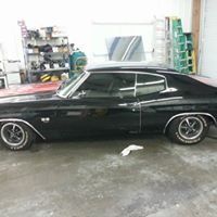A black car is parked in a garage.