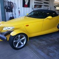 A yellow sports car is parked in a garage.