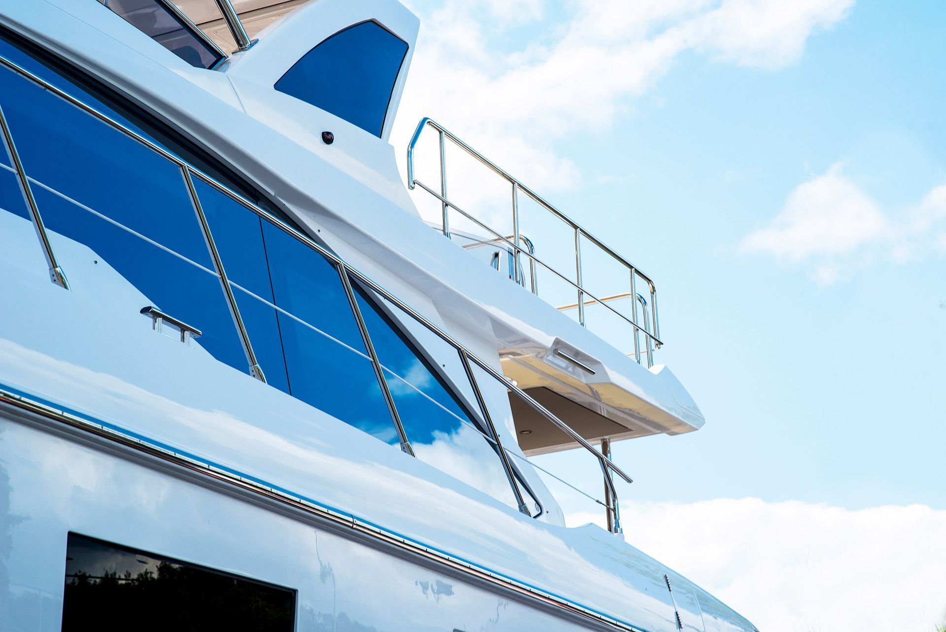 A white and blue yacht with a blue sky in the background