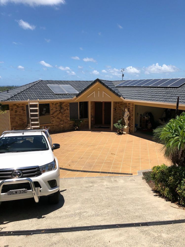 A Large House With Solar Panels on the Roof — Killiby & Co Roofing Pty Ltd in Cabarita Beach, NSW