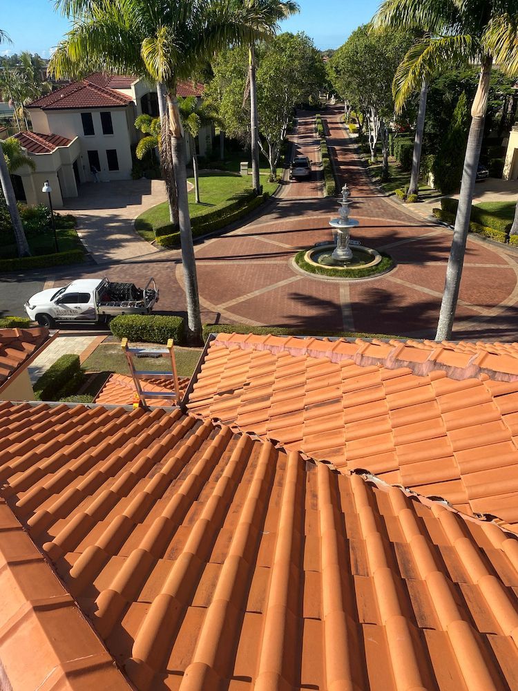 A rooftop view of a residential neighborhood with a fountain in the middle.