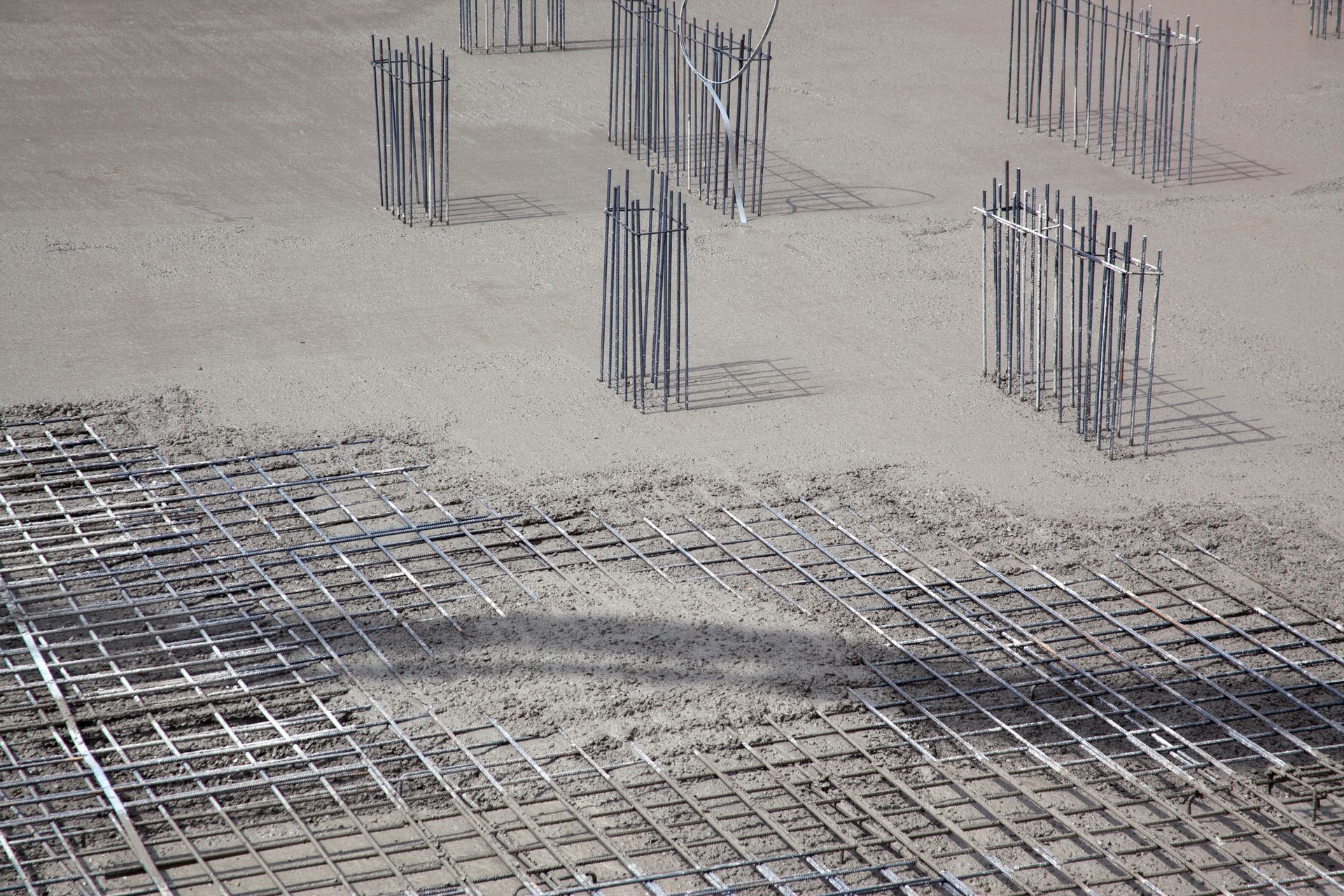 Steel building armature with cement, highlighting steel reinforcement techniques. Steel building armature with cement, highlighting steel reinforcement techniques.