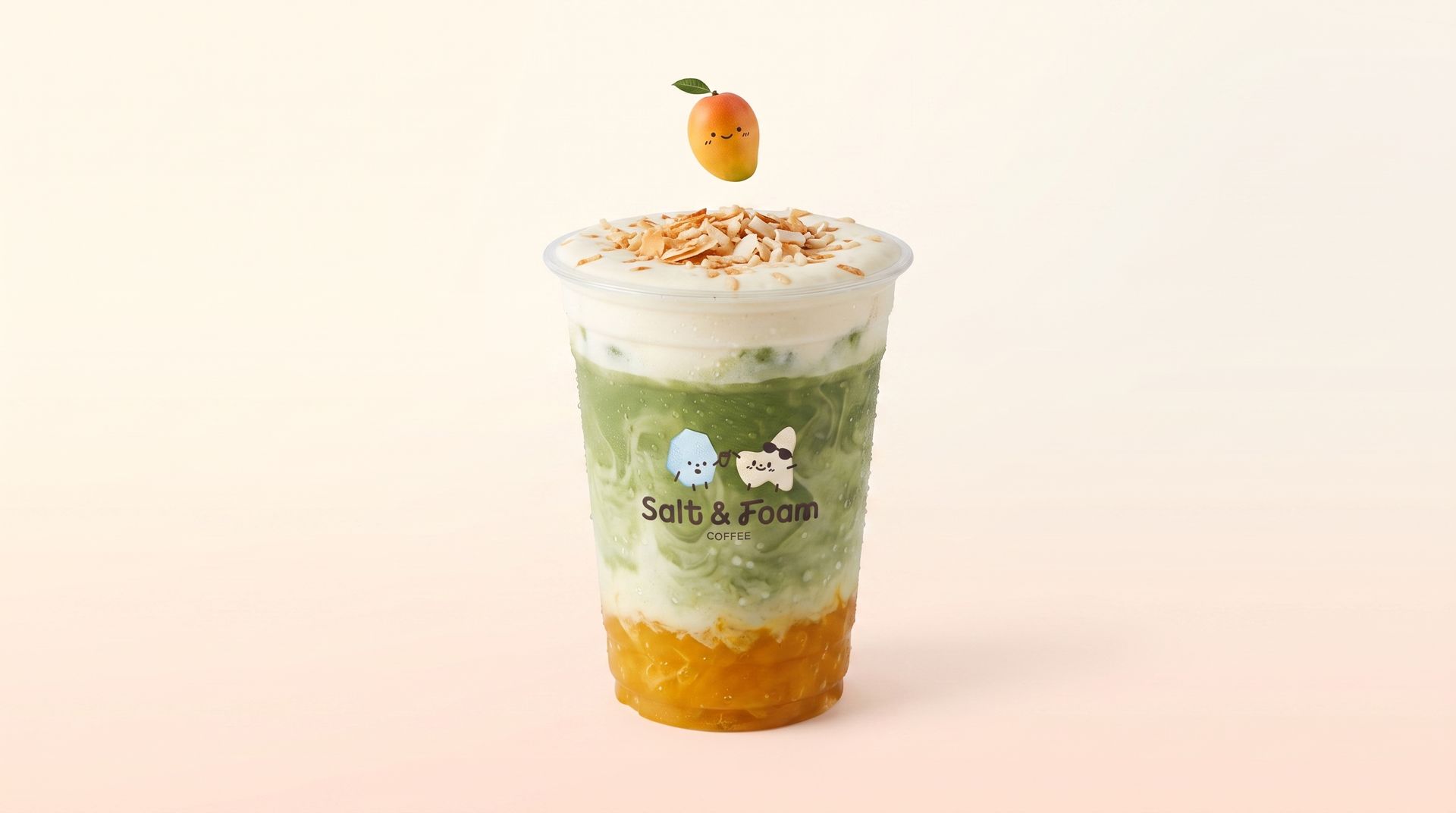 Green layered drink with whipped cream, orange topping, and a fruit garnish in a clear cup