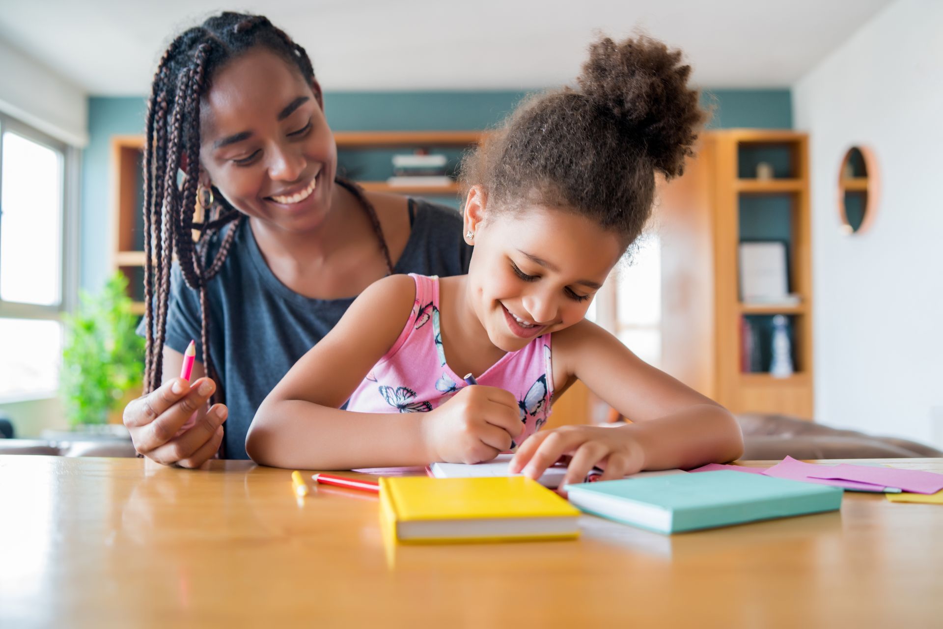 Parent teaching child at home, illustrating how to homeschool in California.