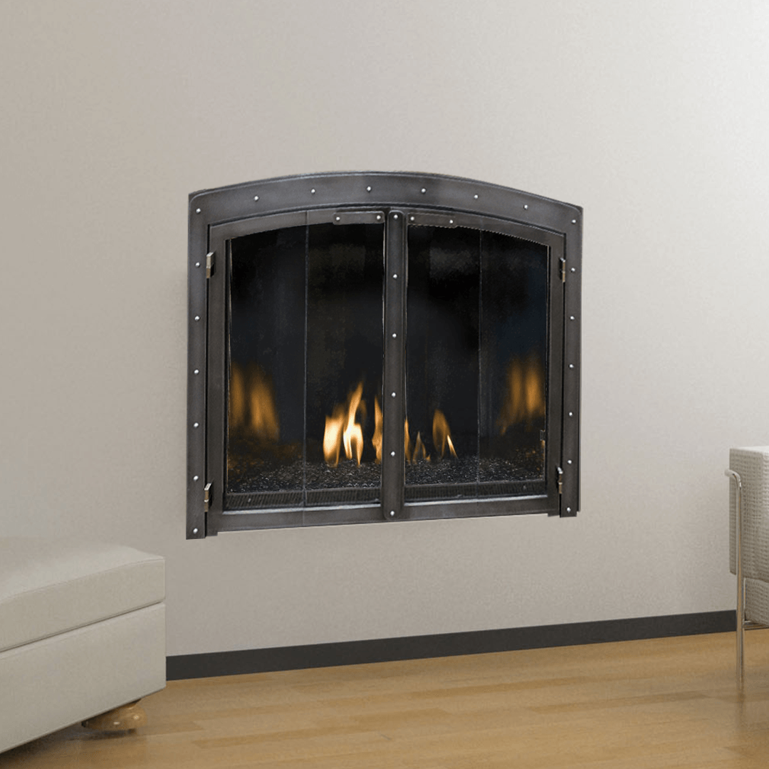 Fireplace with arched metal frame and glass doors, flames visible.