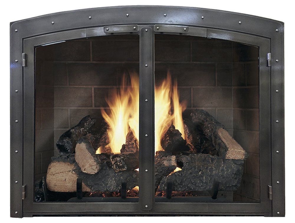 Fireplace with burning logs behind a metal-framed glass screen. Brick background.