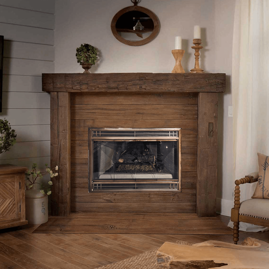 Rustic wooden fireplace with mantel, decorated with candles and greenery in a cozy living room.
