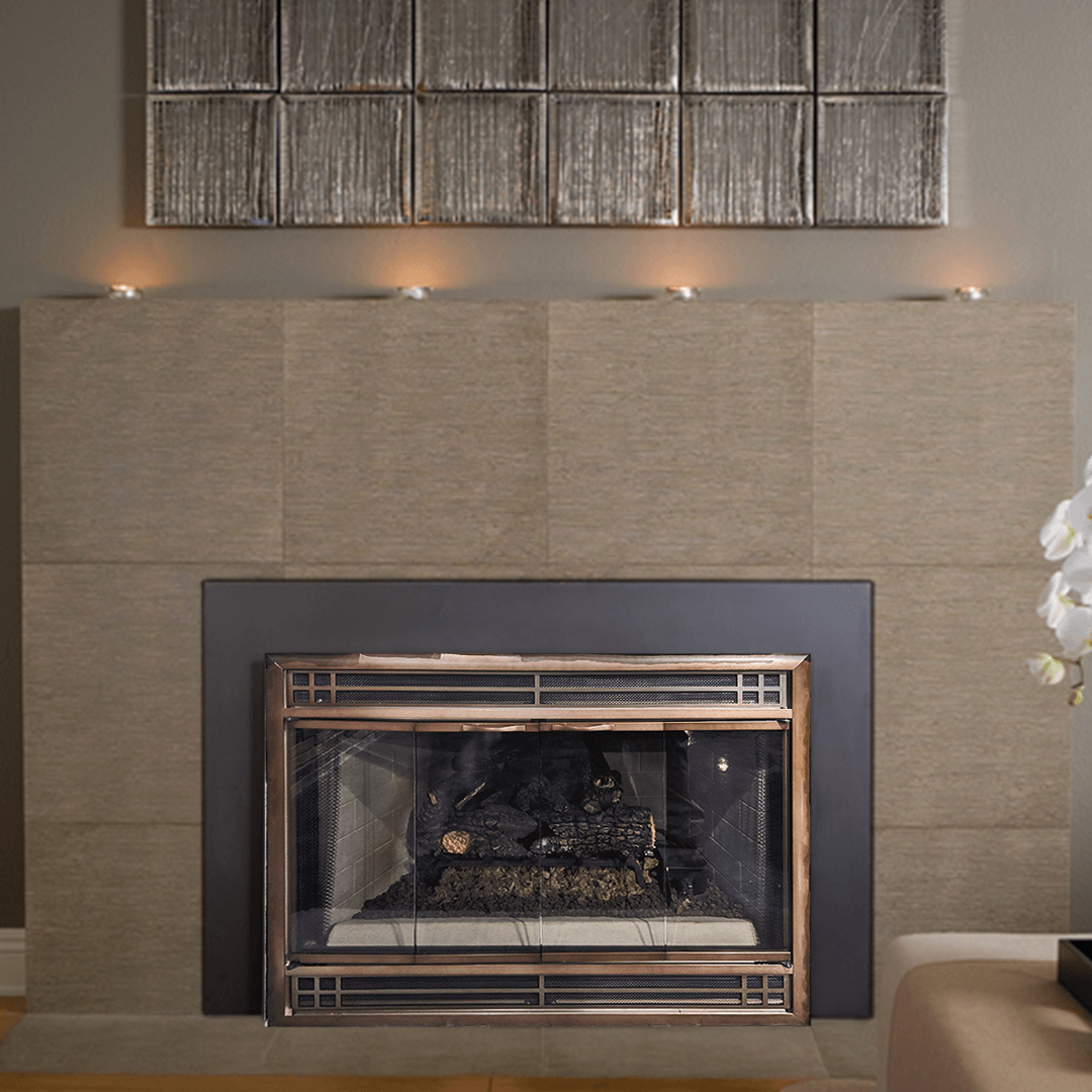 Fireplace with tan tiled surround, black firebox, and decorative candles. Wooden artwork above.