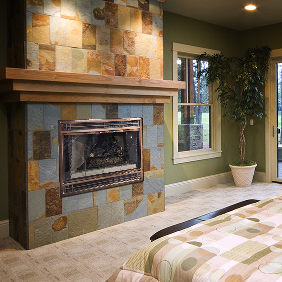Fireplace with stone surround and wooden mantel in a green-walled room. A large tree sits nearby.