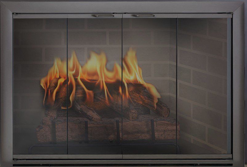 Fireplace with glass doors and burning logs. Brick background.