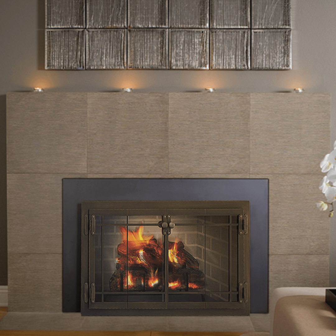 Fireplace with burning logs, metal doors, and a stone surround, candles above.